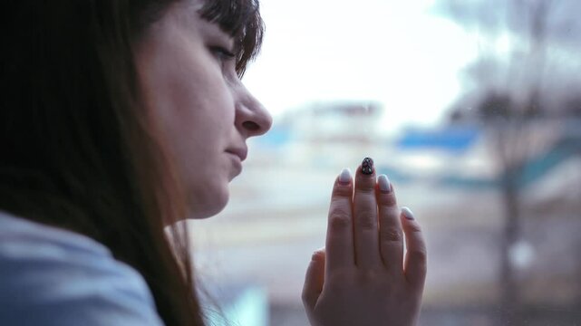 Thoughtful Interlude: Woman by the Window, Introspectively Drawing a Heart