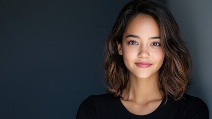 Fototapeta premium Portrait of a Young Woman with Natural Makeup and Soft Smile