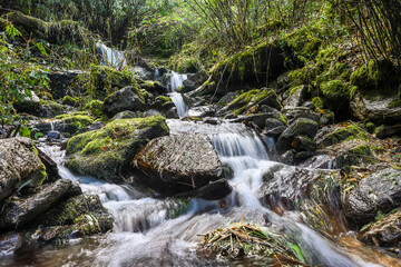 A beautiful waterfall flowing through lush green Annapurna Conservation Area, Nepal