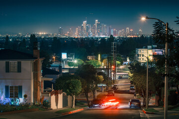 City of Los Angeles skyline at night, picturing local street traffic and downtown LA skyline in the background.