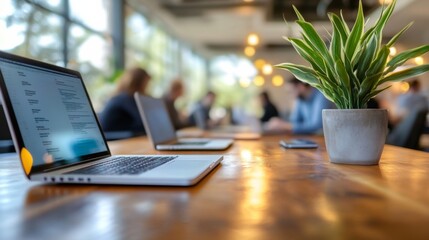 Diverse team collaborating on laptops in a busy coworking office, with a blurred background.