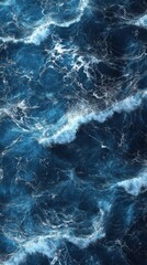 Fototapeta premium A stunning view of deep blue ocean waves, capturing the dynamic movement and frothy whitecaps, evoking a sense of tranquility.