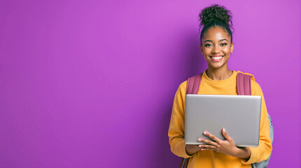 Happy young African American girl holding laptop or computer, smiling female student model with backpack  looking at camera in a purple background. advertising educational program abroad