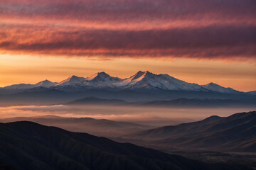 Layers of mountains in silhouette, dark to light; golden sunrise with pink hues, thin clouds reflecting warm light, peaceful and mesmerizing