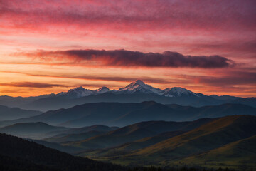 Fototapeta premium Silhouetted mountain layers under a golden-pink sunrise; warm light reflecting on soft clouds, peaceful and enchanting atmosphere