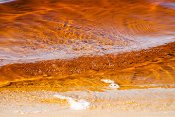 the water surface of a river or lake with sun glare at sunset