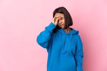 Young latin woman isolated on pink background with tired and sick expression