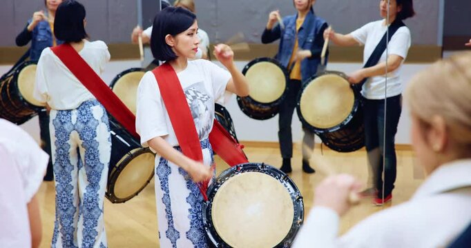 Rhythm, taiko and traditional art for group, instrument and creative for performance, practice and culture. Playing, artistic and Japanese people with drums, religion and skills for music and sticks
