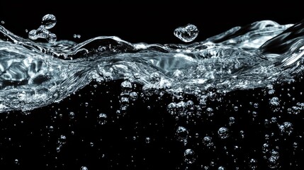 Dynamic water splash with bubbles against a black background, creating a stunning display of motion and clarity.