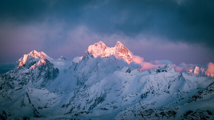 Mount Ushba. Beautiful snowy mountain peaks at sunset
