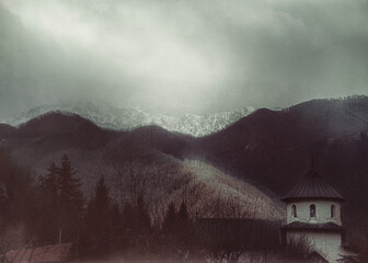 Beautiful view of the monastery and the mountains. A gloomy winter day in the Balkans