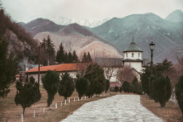 Beautiful view of the monastery and the mountains. A gloomy winter day in the Balkans