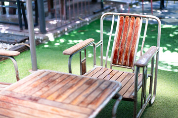 Wooden tables and chairs on the lawn for relaxing and unwinding in the restaurant. Focus on the point