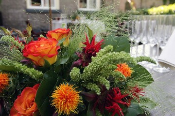 Champagne glasses and flowers at reception ready for the party. 