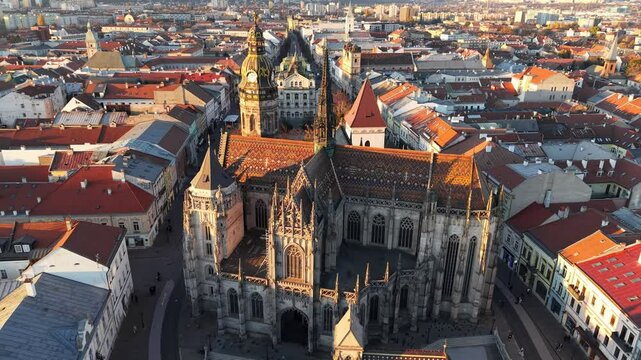 Fly around St. Elisabeth Cathedral in Kosice, Slovakia, during autumn sunset hours with scenic rooftop views of the cityscape. Sunset aerial view of Kosice, Slovakia