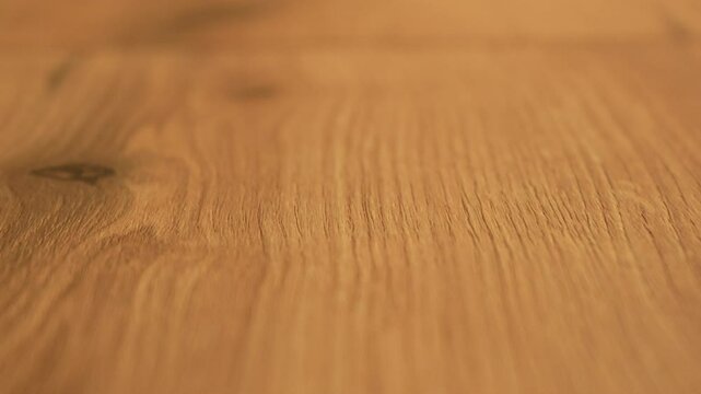 Close up texture of light wooden table top with natural pattern. Part of the video is out of focus. High quality 4k footage