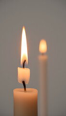 Burning candles close-up, serene mood, warm light for peaceful ambiance and reflection