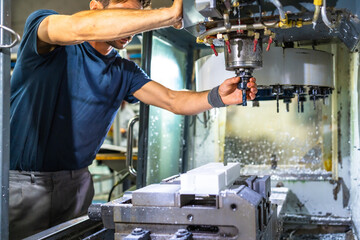 Man working in the machining center for plastic parts © unai