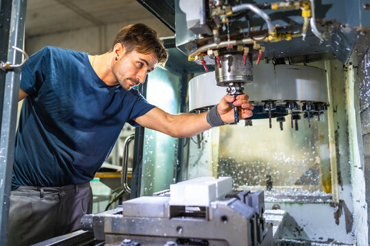 Technician working with mechanic machine to produce plastic parts