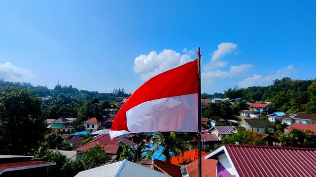 The red and white flag fluttering in the wind