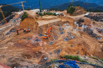 construction site with excavators digging pit for foundation of a building under construction
