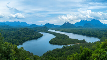 Fototapeta premium Winding river through lush Thai rainforest under cloudy sky.