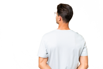 Young caucasian handsome man over isolated background in back position and looking back
