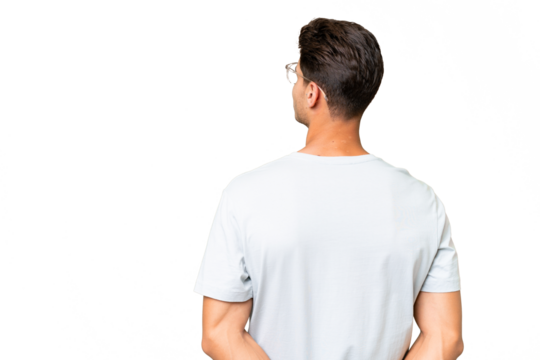 Young caucasian handsome man over isolated background in back position and looking back