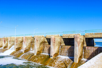 Obraz premium Hydroelectric dam spillway with multiple gates, water infrastructure and renewable energy generation facility