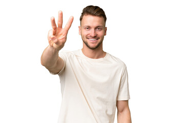 Young blonde caucasian man over isolated background happy and counting three with fingers