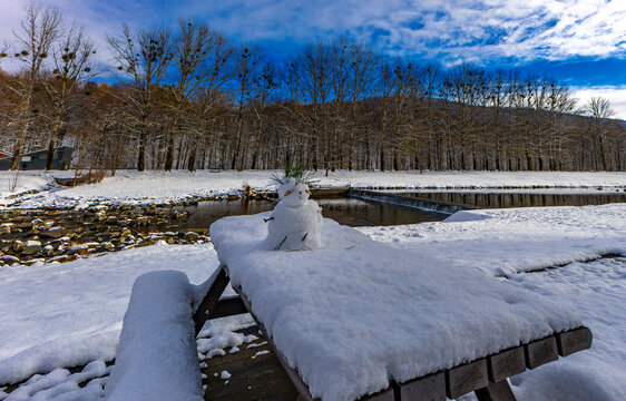 Little snowman made of snow by the river