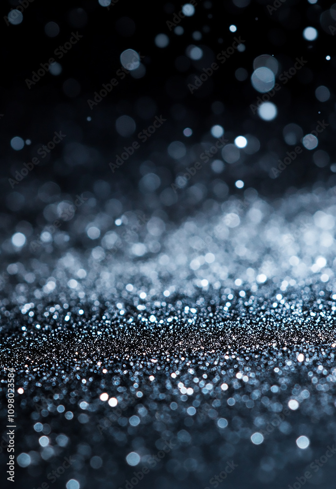 Wall mural shimmering silver sparkles on a dark background create a mesmerizing texture. soft blue lights creat