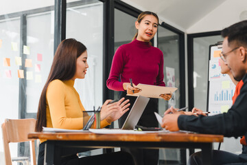 team meeting in modern office with woman presenting ideas. atmosphere is collaborative and focused, showcasing teamwork and communication