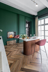 Obraz premium A spacious kitchen showcases a rich green color scheme, featuring a sleek marble island, elegant pink bar stools, and wooden flooring, creating a warm, inviting atmosphere fireplace inside the wall