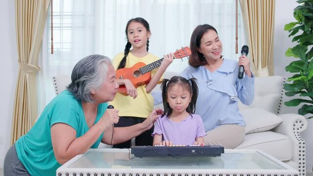 Happy family, mother and daughter are having fun playing music and singing
