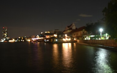 Obraz premium blurry of light bulb on street in river on Thailand
