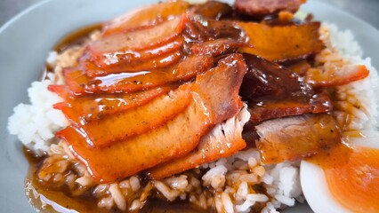 Red pork and crispy pork on rice, food in Thailand.