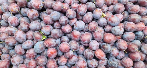 Plums in brown-red color for sale in a stall