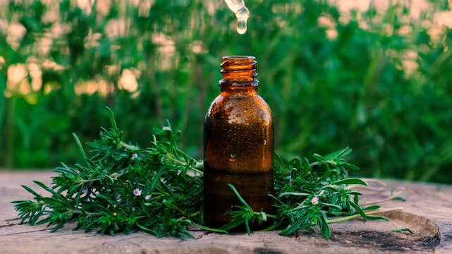 Thyme extract in a bottle. Selective focus.