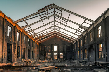 Interior of abandoned industrial building with exposed rafters