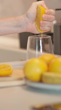 The refreshing experience of a juicy lemon squeezed in a bright modern kitchen, surrounded by colorful fresh fruits, adds a vibrant touch to any culinary space, enhancing aesthetics and atmosphere