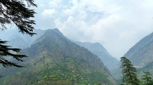 Small villages and colorful local houses nested in the hills of parvati valley at manikaran, himachal pradesh, India.