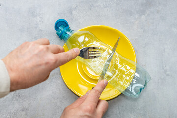 Microplastic in food, Concept, Global environmental problem, Plastic PET bottle on a plate, Hands...
