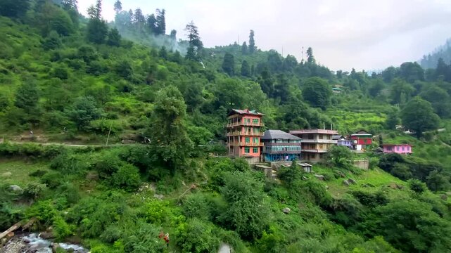 Small villages and colorful local houses nested in the hills of parvati valley at manikaran, himachal pradesh, India.