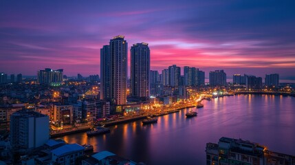 Fototapeta premium A vibrant city skyline at dusk, reflecting lights on the water.