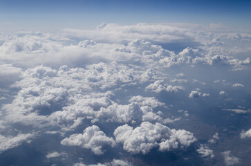 The sky is filled with clouds and the sun is shining through them