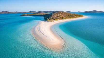 A serene aerial view of a sandy beach island surrounded by turquoise waters and distant hills.