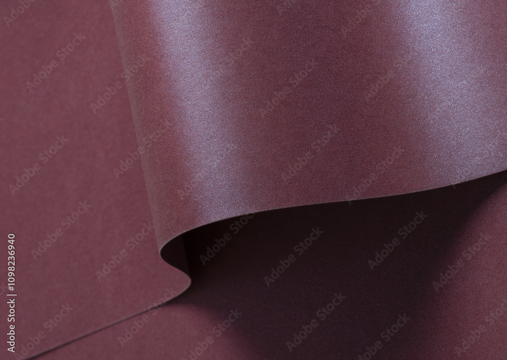 Aufkleber burgundy metallic paper background with a shimmering, sleek surface and soft folds. featuring a rich