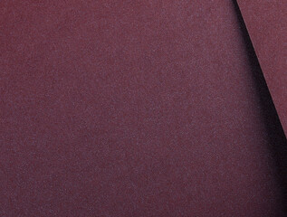 Fototapeta premium Burgundy metallic paper background with a smooth, shimmering surface and elegant gradient. Featuring soft folds and a glossy, reflective finish, it exudes a luxurious and refined