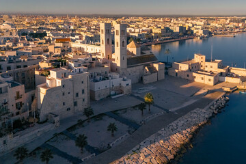 Aerial view old Mediterranean coastal city with big cathedral on sunny day, Molfetta, Puglia, Italy